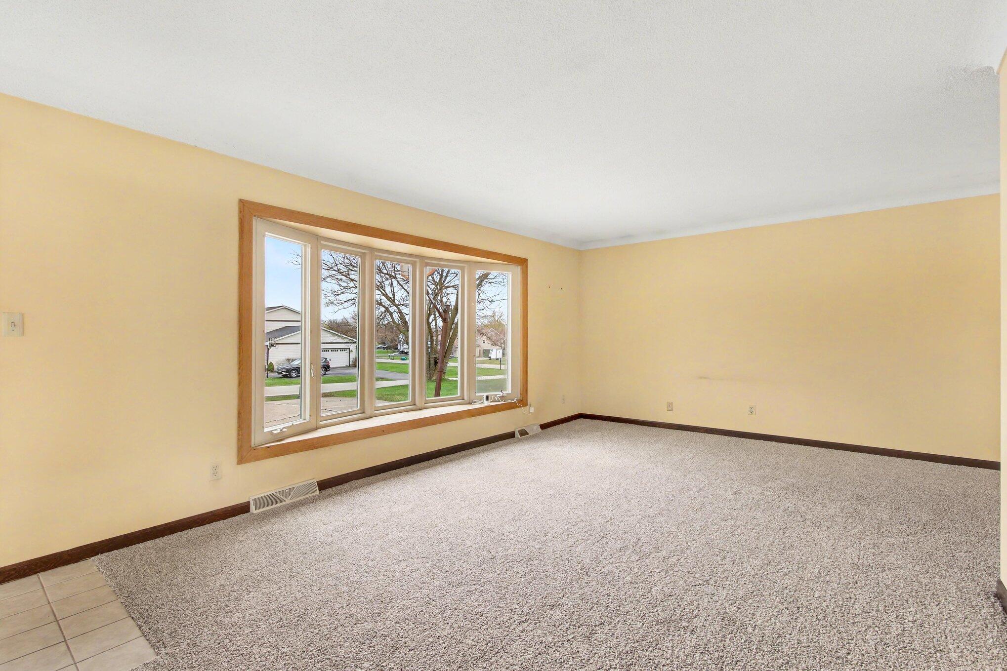 1379 Leeward Road Crown Point, IN 46307 - Photo 6 of 39 an empty room with a large window