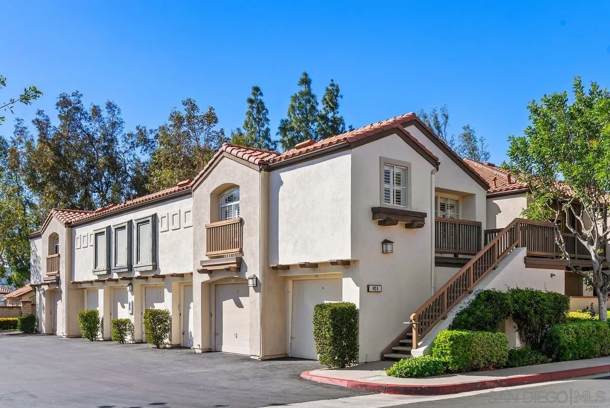 a view of a white house with a large windows
