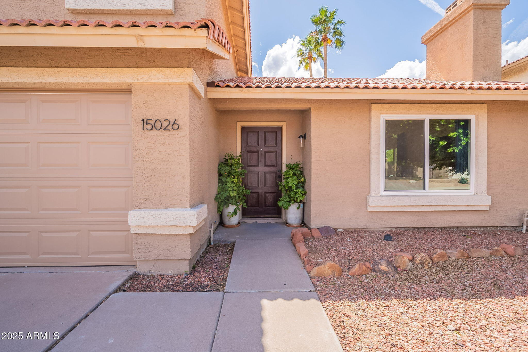 15026 South 28th Street Phoenix, AZ 85048 - Photo 2 of 40 a front view of a house with a yard and potted plants