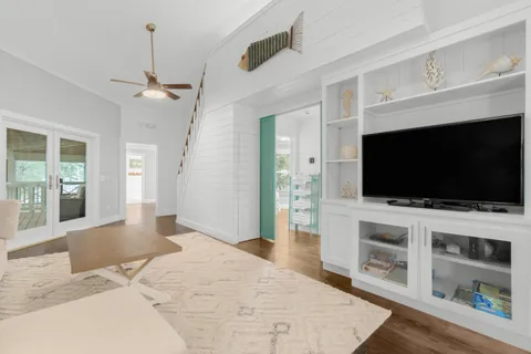 a view of a livingroom with wooden floor and a flat screen tv