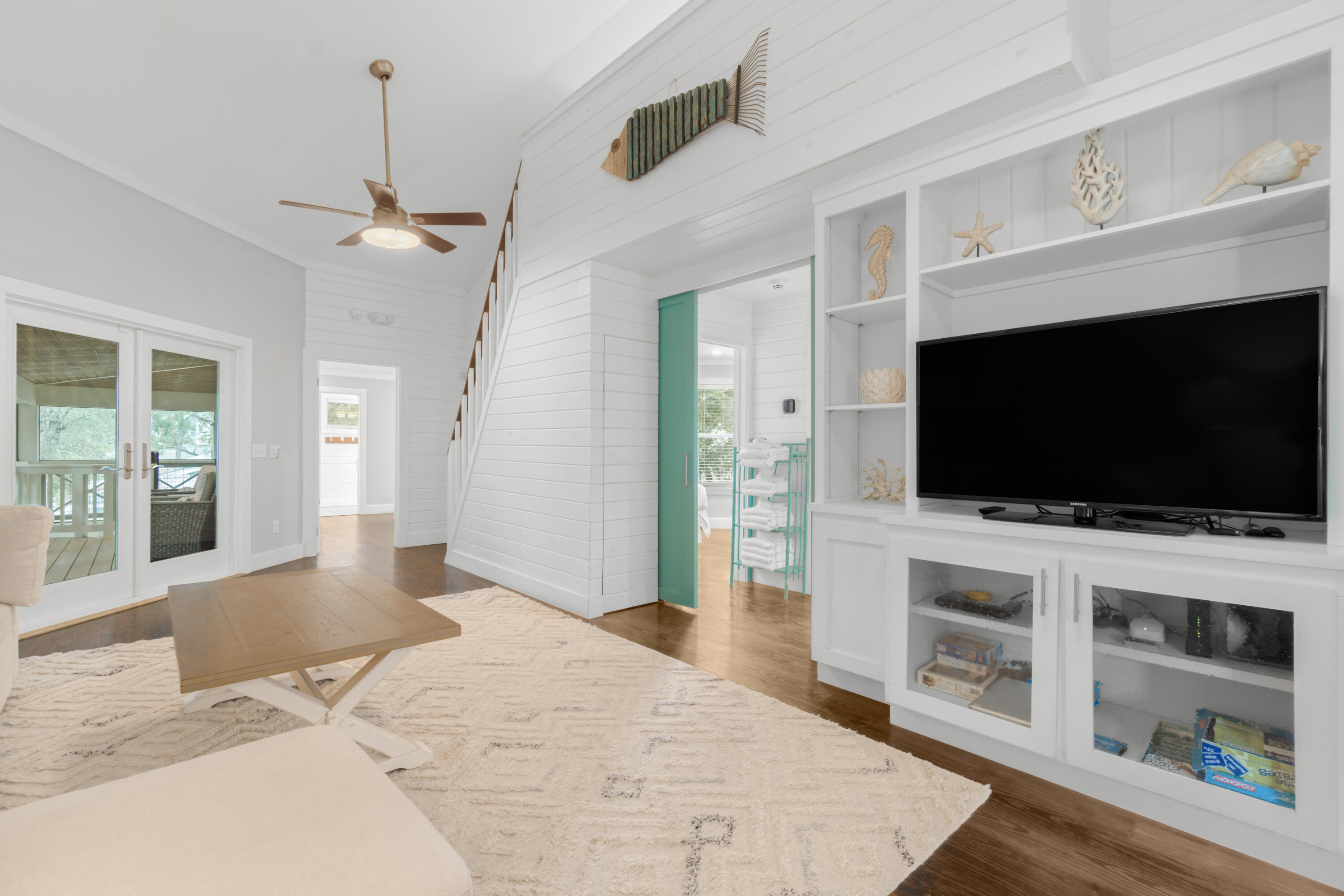 127 Dogwood Street Santa Rosa Beach, FL 32459 - Photo 13 of 22 a view of a livingroom with wooden floor and a flat screen tv