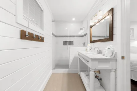 a bathroom with a sink a mirror and a shower