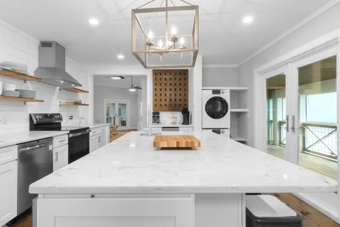 a bedroom with a large bed and a chandelier
