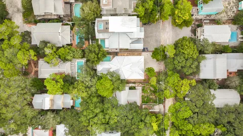 an aerial view of a house with a yard and lake view