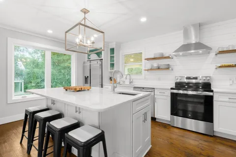a kitchen with a stove a sink and a refrigerator