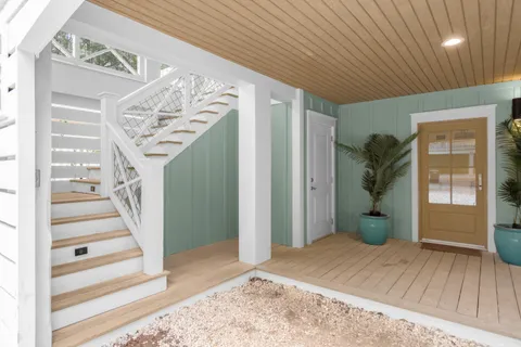 a view of a livingroom with wooden floor and stairs