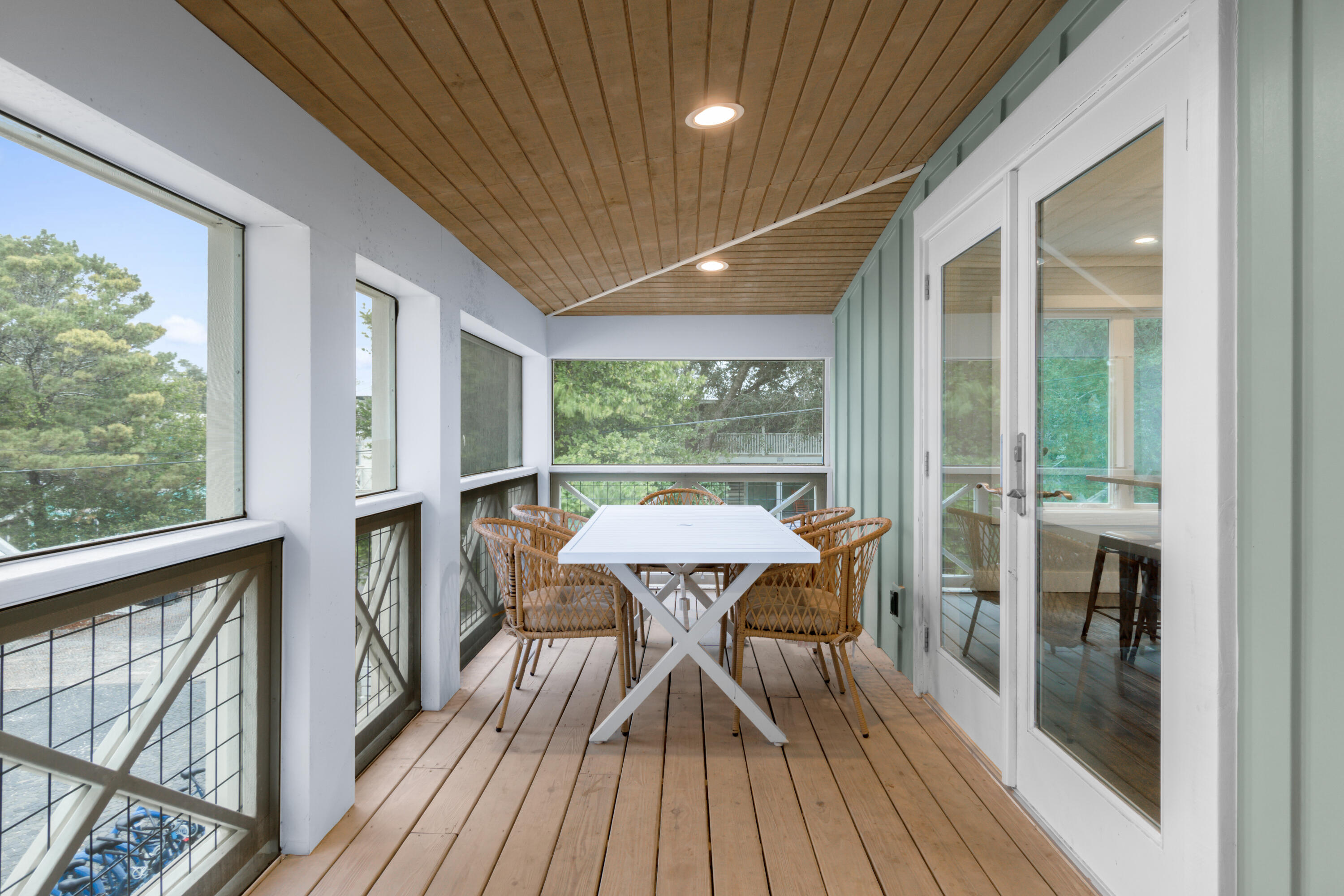 127 Dogwood Street Santa Rosa Beach, FL 32459 - Photo 7 of 24 a view of a porch with furniture and wooden floor