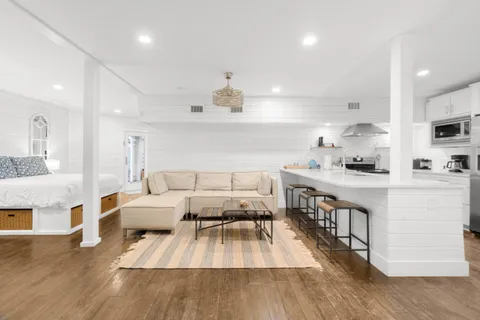 a kitchen with counter top space a sink appliances and cabinets