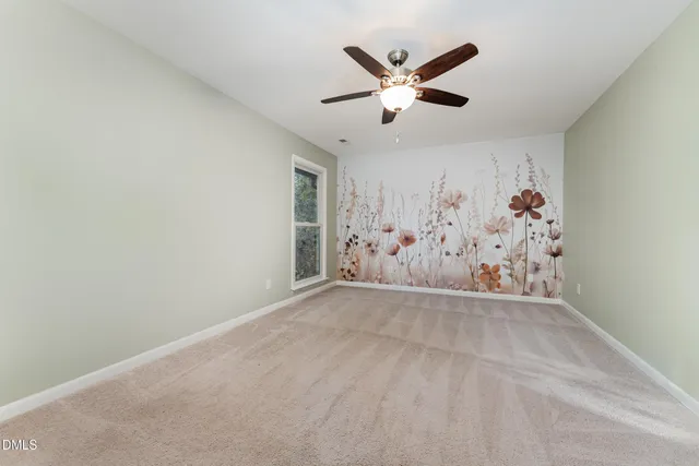 an empty room with wall painting and window