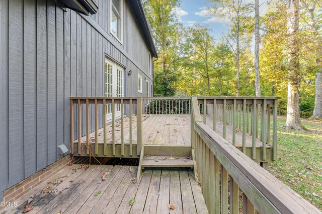 a view of balcony with wooden floor and fence