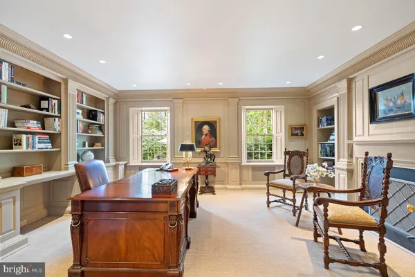 a kitchen with stainless steel appliances a table chairs and a refrigerator