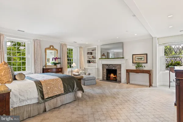 a bedroom with a bed couch and a window