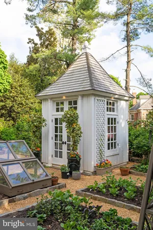 a front view of a building with a garden