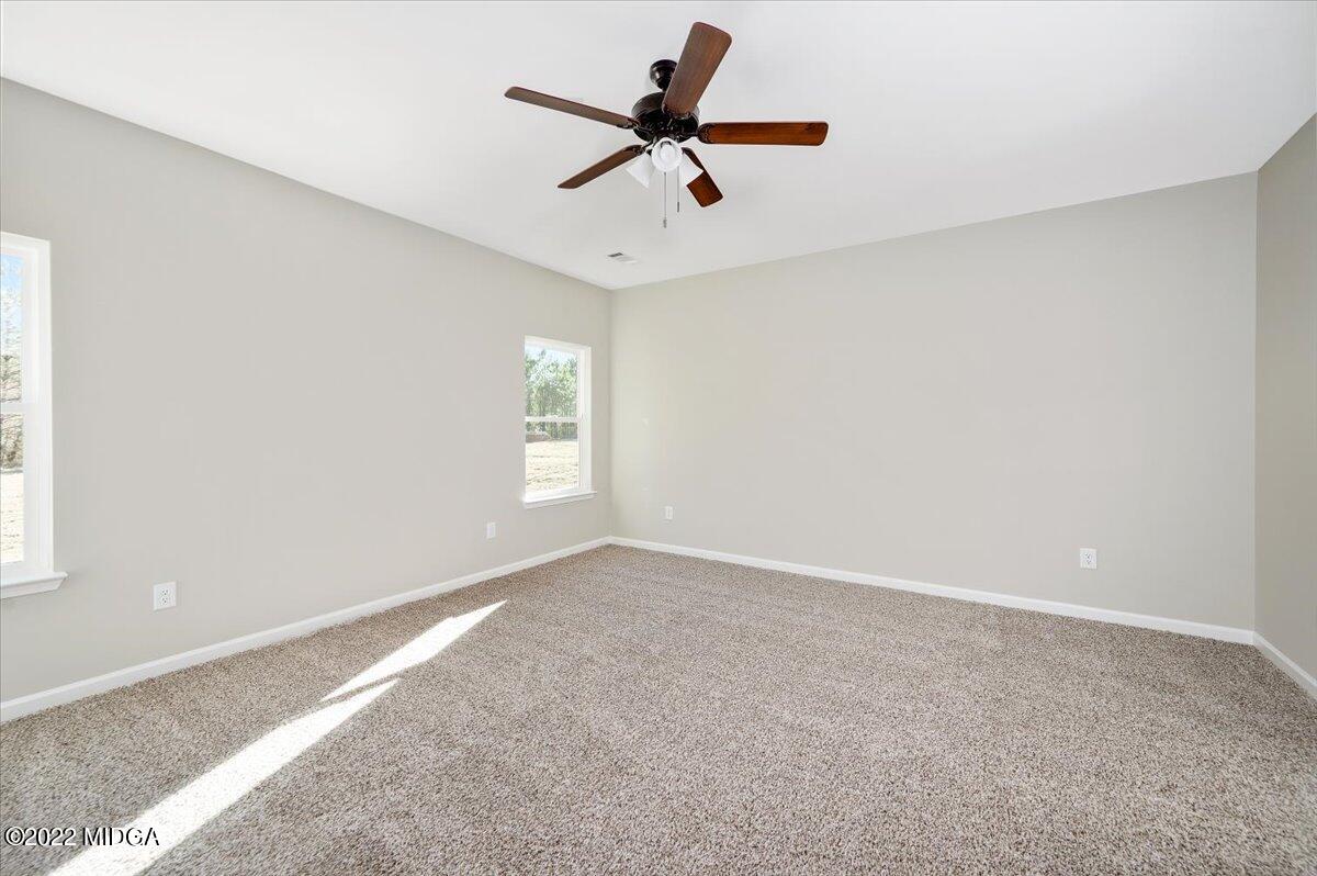 229 Davis Road Gray, GA 31032 - Photo 13 of 30 a view of an empty room with a window