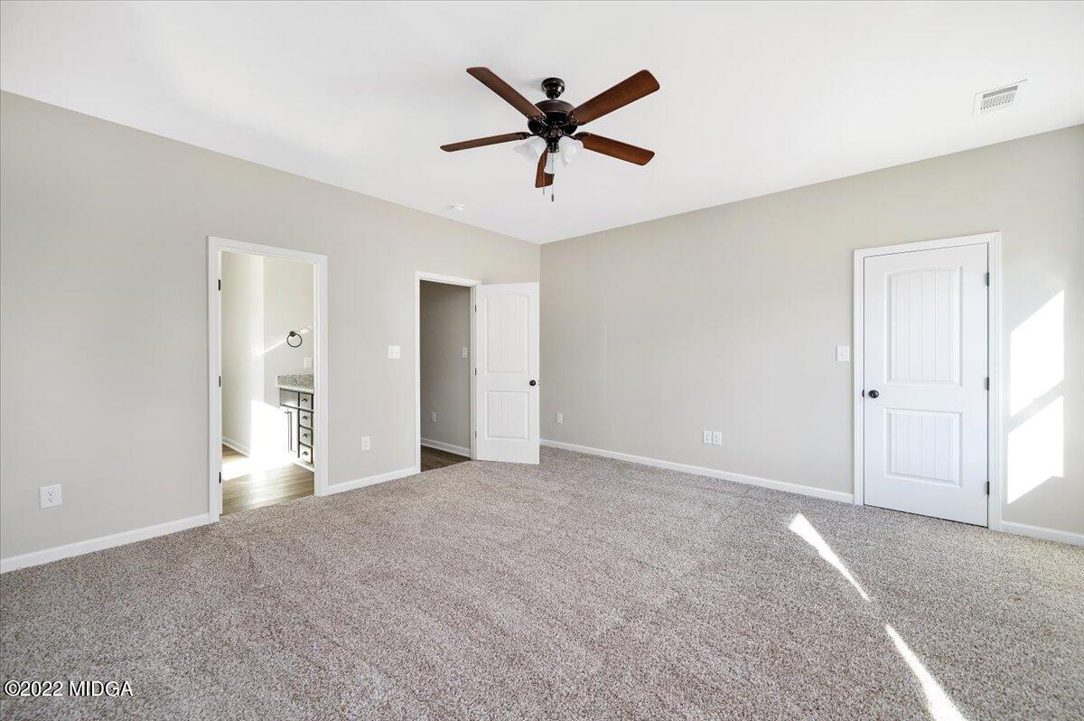 229 Davis Road Gray, GA 31032 - Photo 14 of 30 a view of a livingroom with a ceiling fan and wooden floor