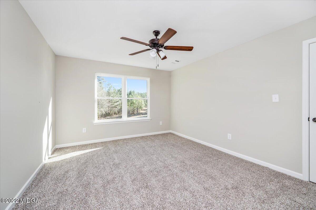 229 Davis Road Gray, GA 31032 - Photo 19 of 30 an empty room with windows and fan