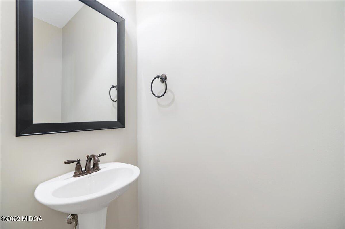 229 Davis Road Gray, GA 31032 - Photo 25 of 30 a bathroom with a sink and a mirror