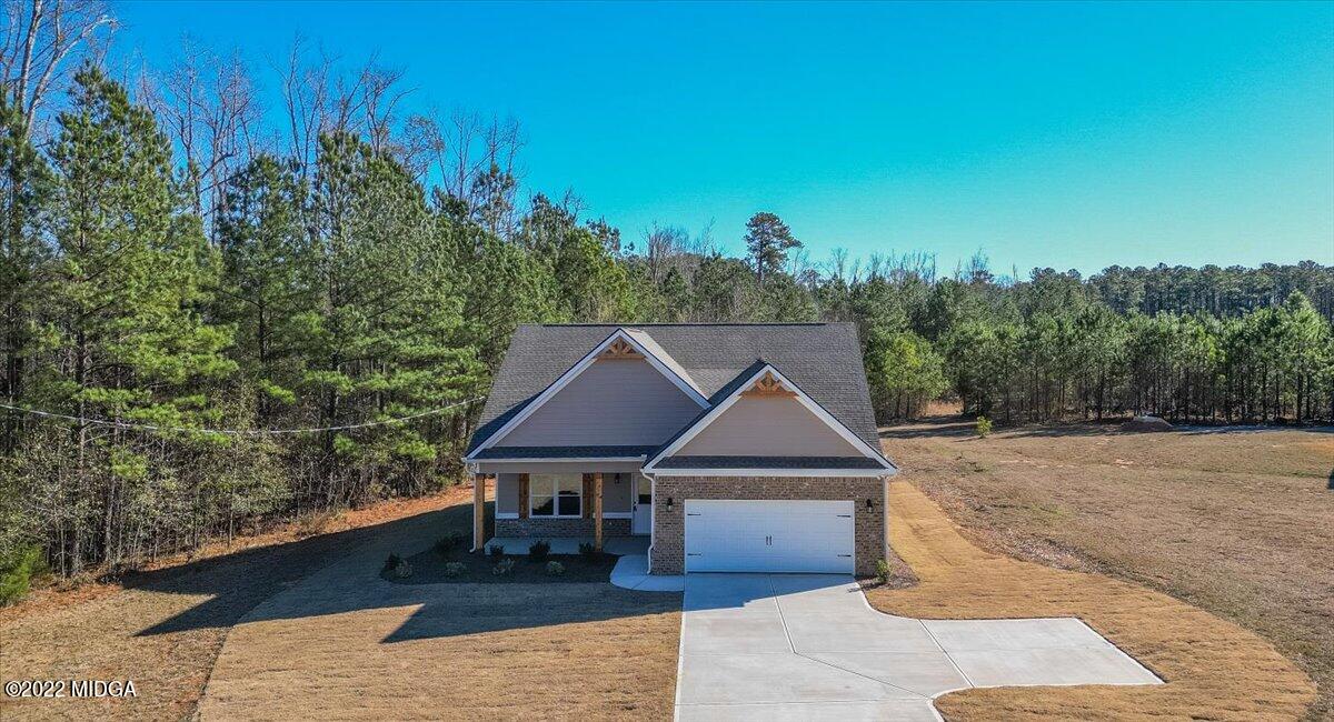 229 Davis Road Gray, GA 31032 - Photo 27 of 30 a front view of a house with yard garage and trees