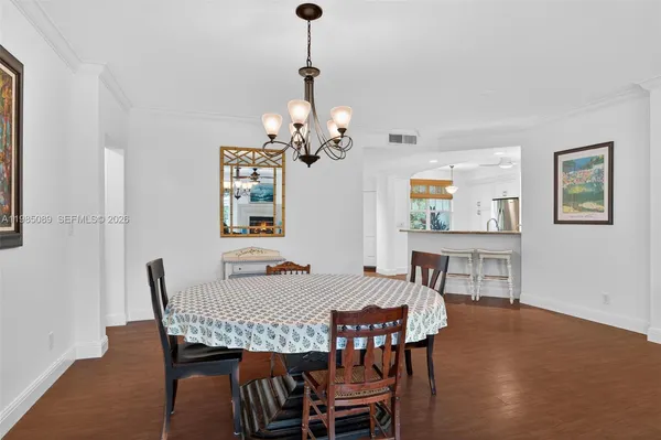 a view of a dining room with furniture wooden floor and a chandelier