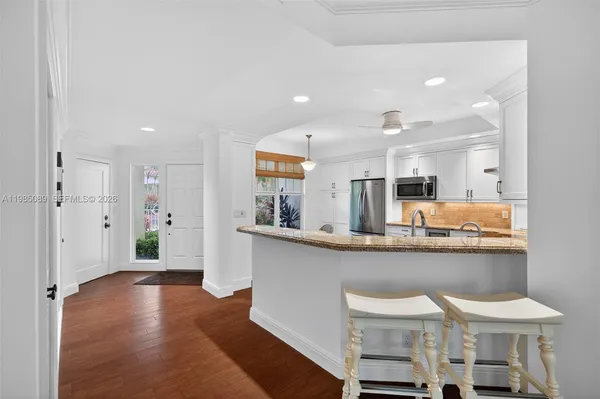 a kitchen with stainless steel appliances granite countertop a sink and cabinets