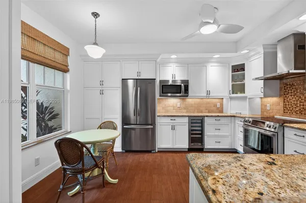 a kitchen with refrigerator cabinets dining table and chairs