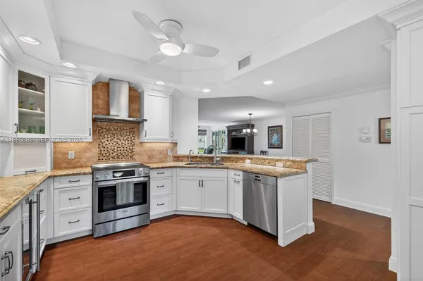 a kitchen with stainless steel appliances granite countertop a stove and a sink