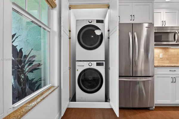 a utility room with sink dryer and washer