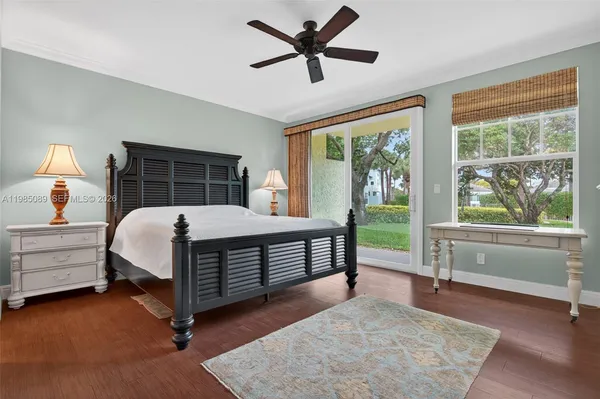 a bedroom with a bed and a large window