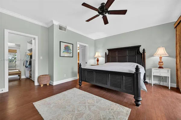 a bedroom with furniture and a wooden floor