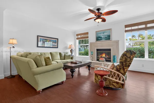 a living room with furniture wooden floor and a fireplace