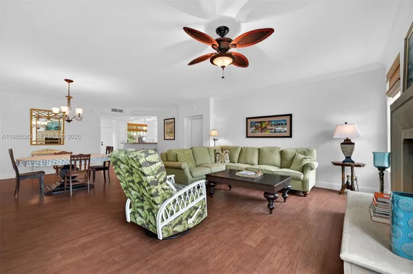 a living room with furniture wooden floor and a window