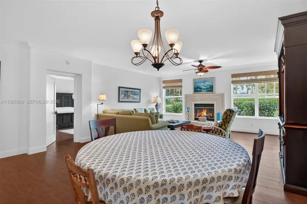 a living room with furniture a fireplace and a chandelier