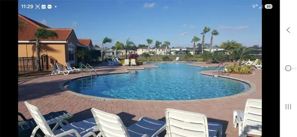 a view of a swimming pool with outdoor seating
