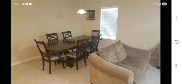 a dining room with furniture and wooden floor