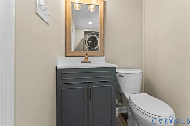 a bathroom with a toilet a sink and mirror
