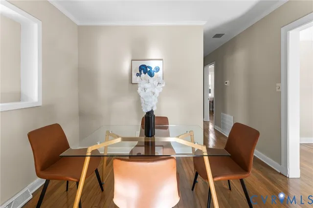 a dining room with furniture and wooden floor