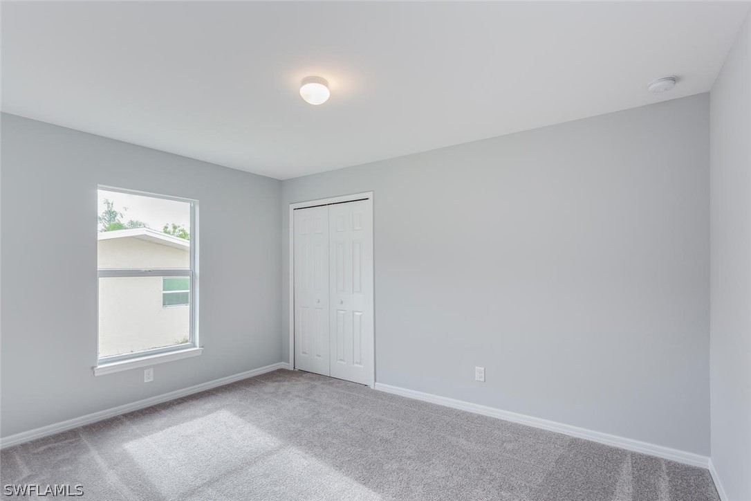 19022 Coconut Road Fort Myers, FL 33967 - Photo 8 of 18 an empty room with windows