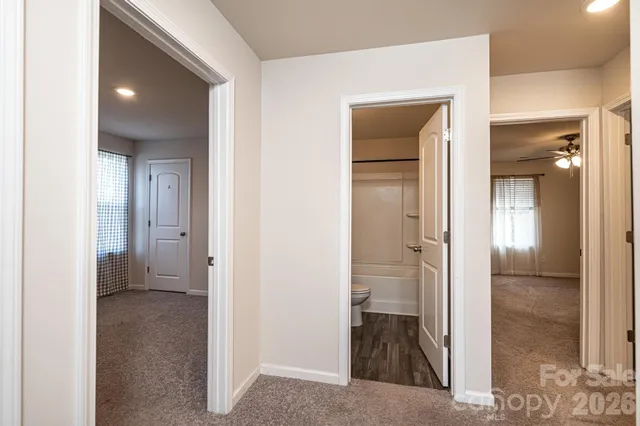 a view of a bathroom with a glass door and a bathroom