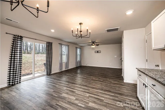 a view of a kitchen with wooden floor and a sink