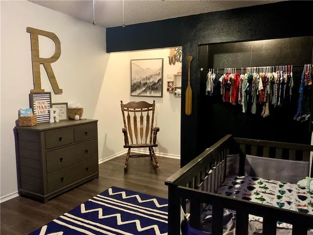 a view of a hallway with a tv and couches