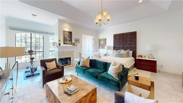 a living room with furniture fireplace and a window