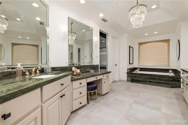a spacious bathroom with double vanity and a mirror