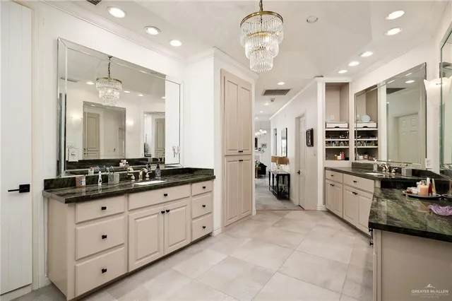 a spacious bathroom with a double vanity sink a mirror and a bathtub