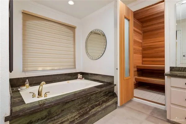 a bathroom with a granite countertop tub and a sink