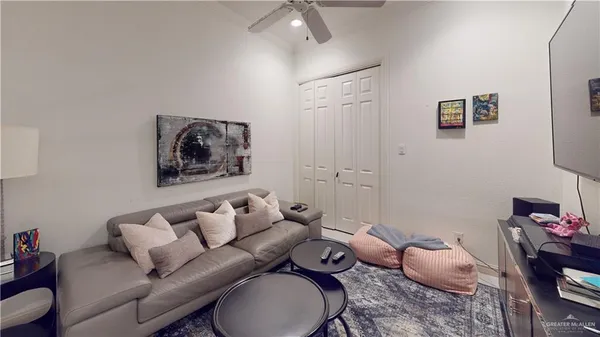 a living room with furniture and a baby crib