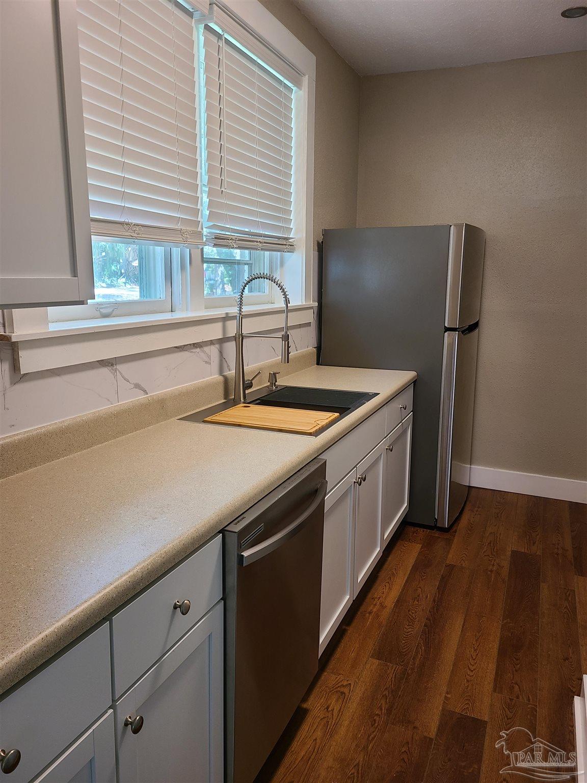 504 North Spring Street, Unit B Pensacola, FL 32501 - Photo 4 of 14 a kitchen with a sink and a window