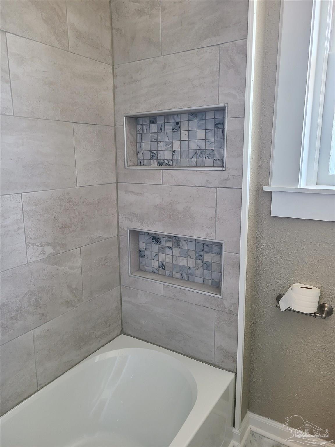 504 North Spring Street, Unit B Pensacola, FL 32501 - Photo 10 of 14 a bath tub sitting next to a bathroom