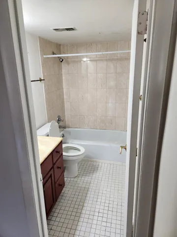 a bathroom with a sink a toilet a mirror and shower