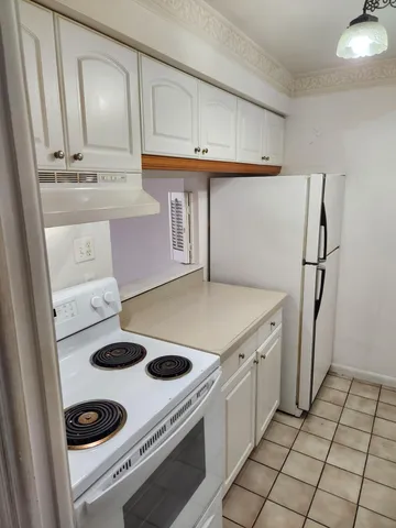 a kitchen with a stove and a refrigerator