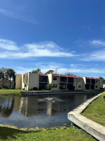 a view of residential houses with outdoor space and lake view